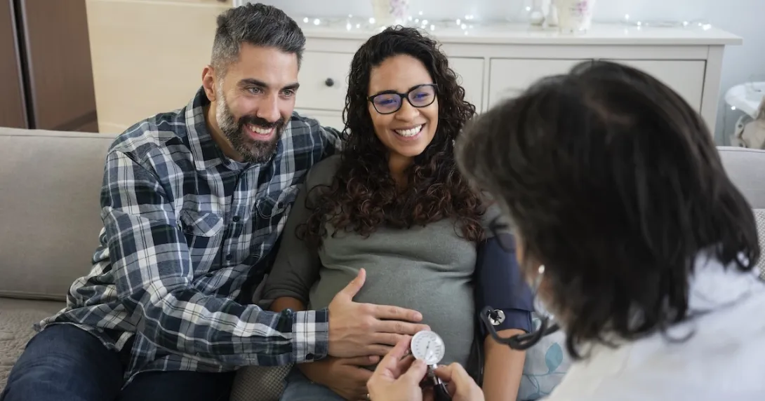Couple, pregnant women consulting with a healthcare professional Couple, pregnant women consulting with a healthcare professional