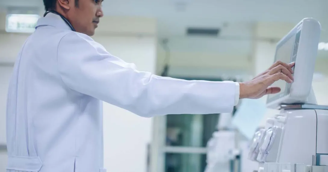 Doctor looking at a dialysis machine while in a care clinic or hospital Doctor looking at a dialysis machine while in a care clinic or hospital