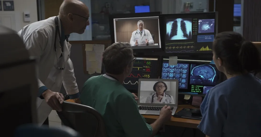 Healthcare professionals reviewing data on computer screens Healthcare professionals reviewing data on computer screens