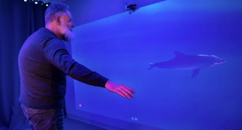 A man playing MindMaze's MindPod game. A man playing MindMaze's MindPod game.