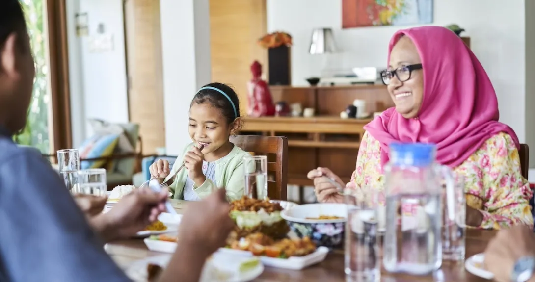 Family sitting at a table eating dinner Family sitting at a table eating dinner