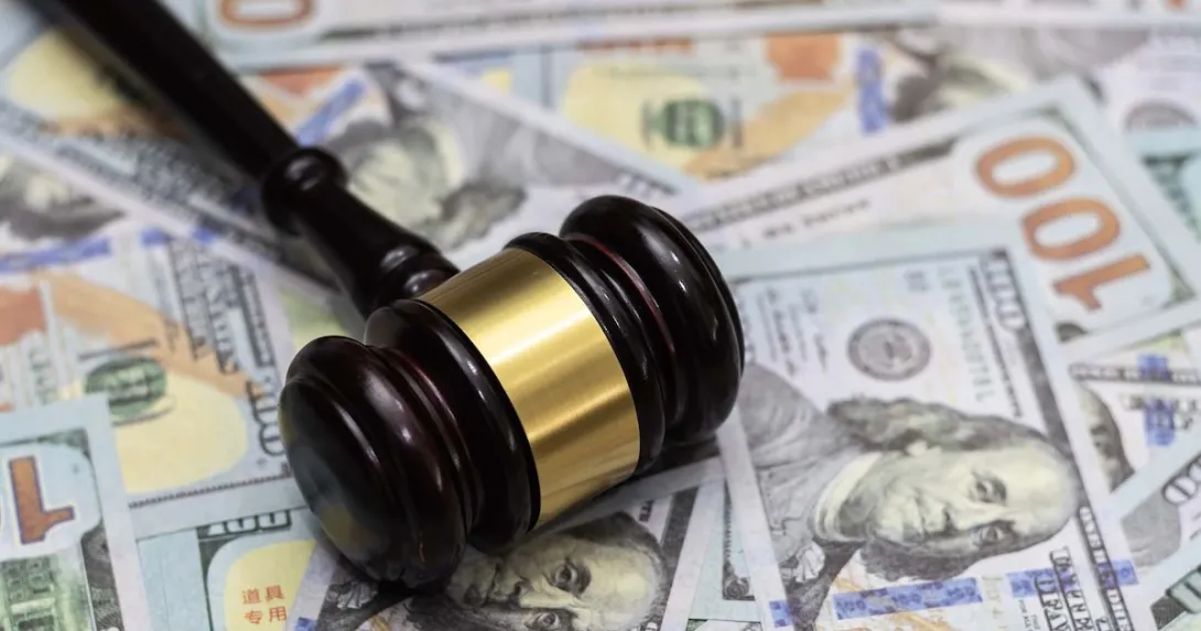 A gavel lying on a pile of money A gavel lying on a pile of money