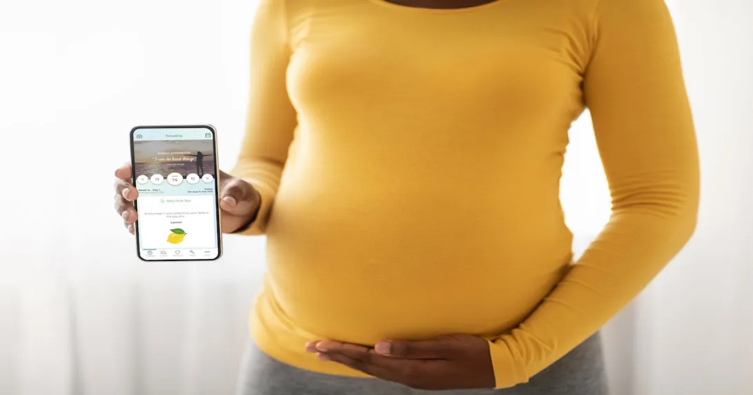 A pregnant women holding a smartphone with the PALS app A pregnant women holding a smartphone with the PALS app