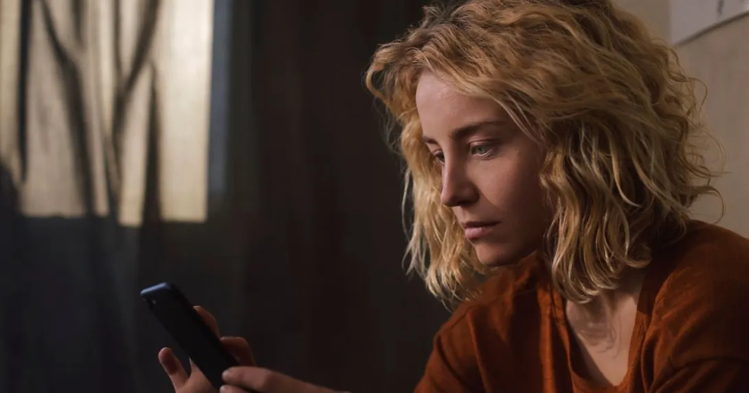 Person looking at a phone Person looking at a phone