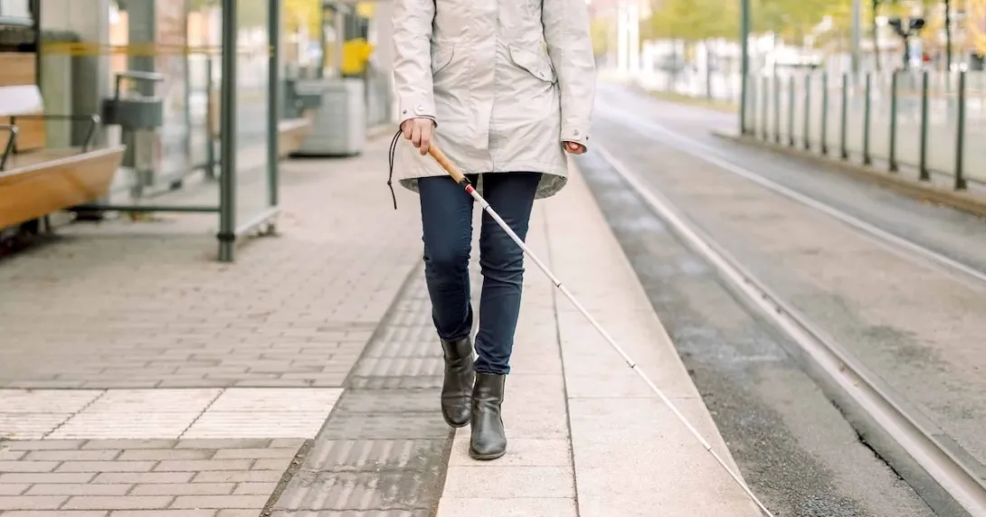 Person walking with a cane Person walking with a cane