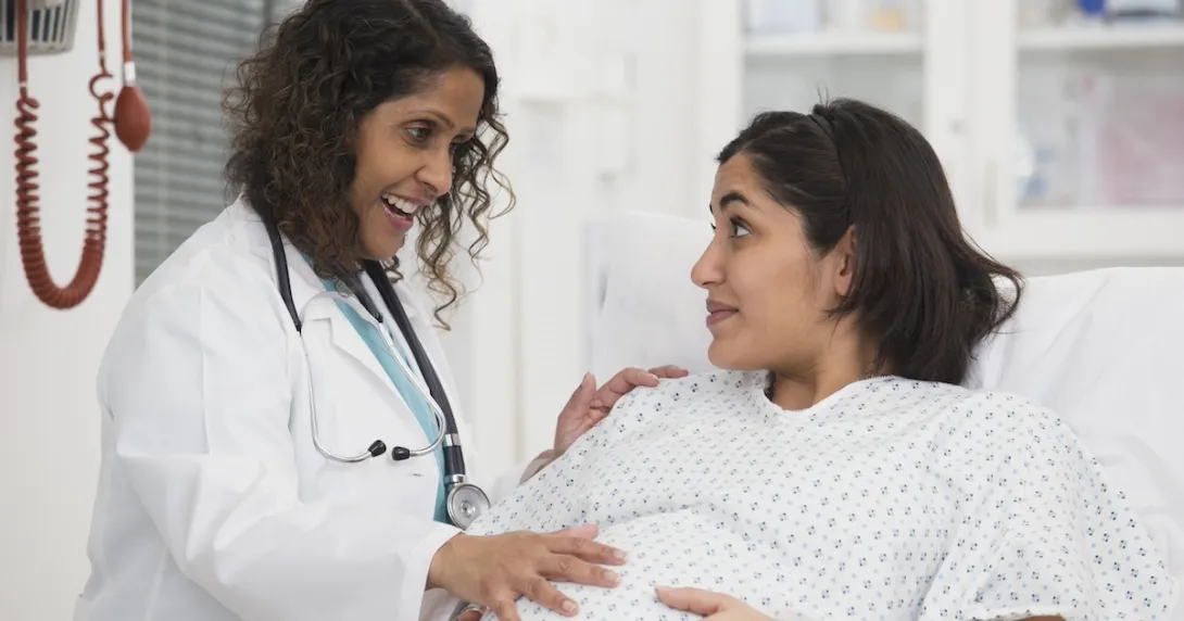 Healthcare professional consulting with pregnant patient Healthcare professional consulting with pregnant patient