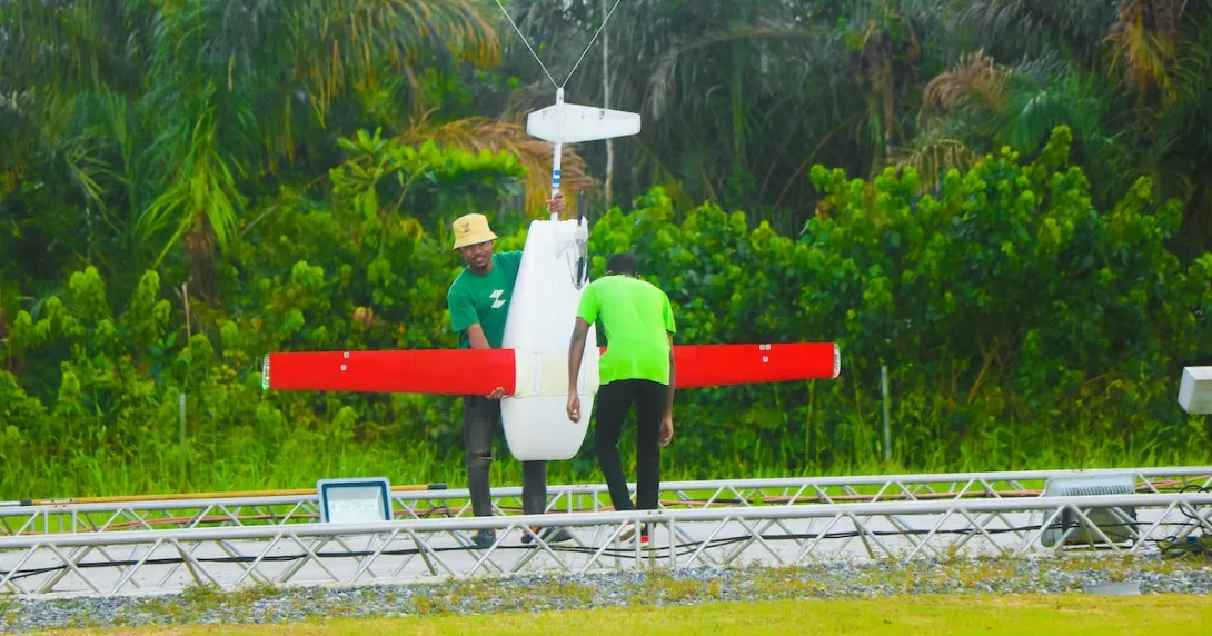 Two individuals preparing a done Two individuals preparing a done