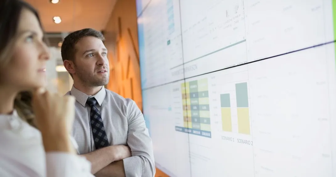 Businesspeople looking at financial charts. Businesspeople looking at financial charts.