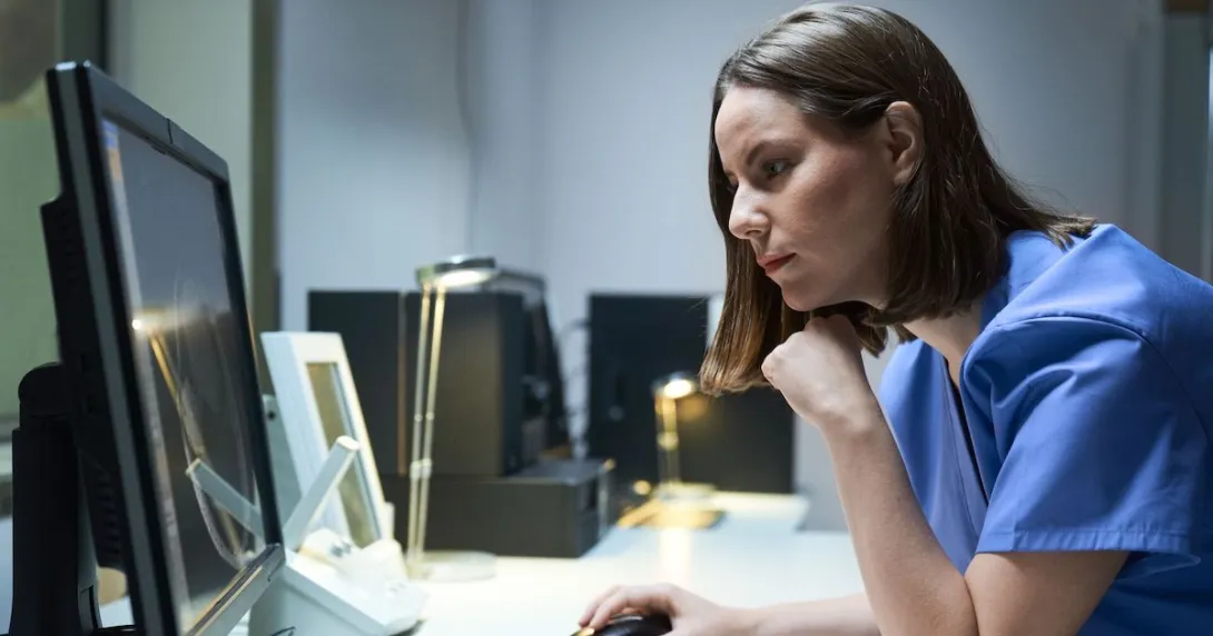 A doctor looking at imaging results on a desktop computer. A doctor looking at imaging results on a desktop computer.