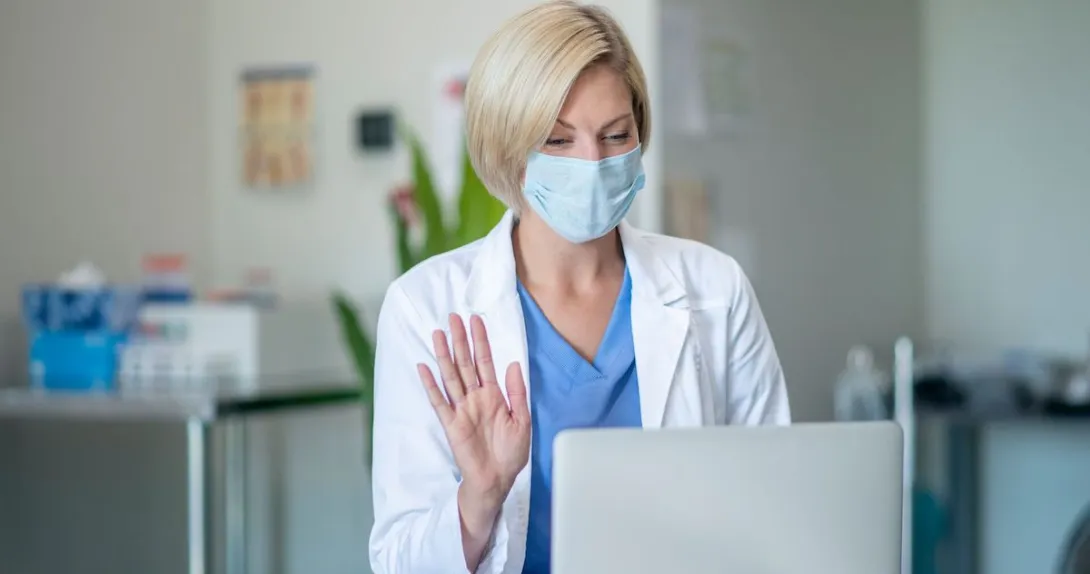 A doctor recording a video on her laptop. A doctor recording a video on her laptop.