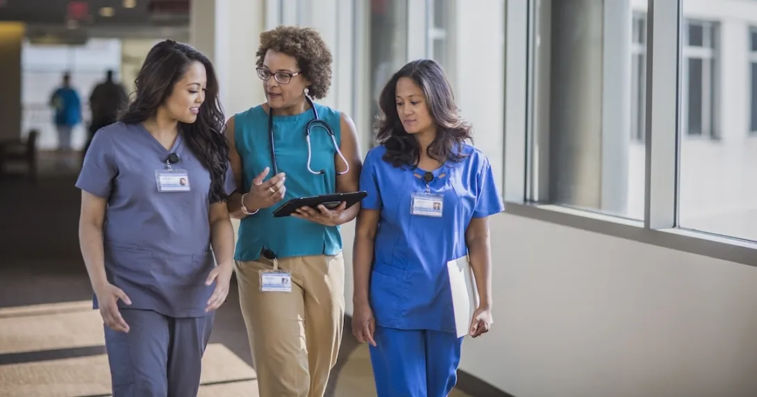 A doctor and nurses walking together in a hospital. A doctor and nurses walking together in a hospital.