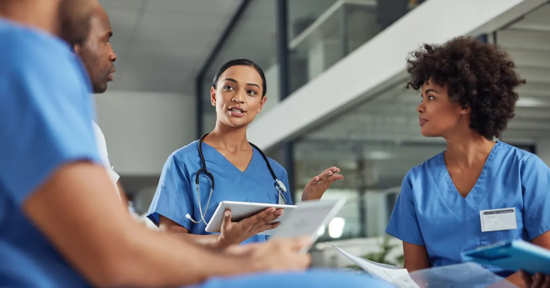 A group of medical practitioners having a discussion in a hospital. A group of medical practitioners having a discussion in a hospital.