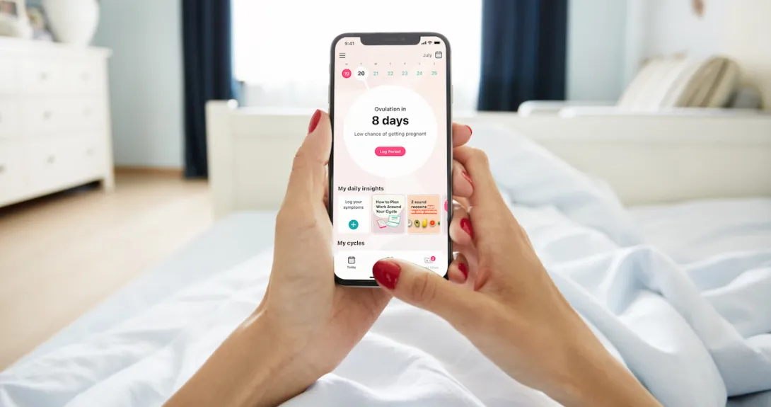 A close up of a woman using the Flo app A close up of a woman using the Flo app