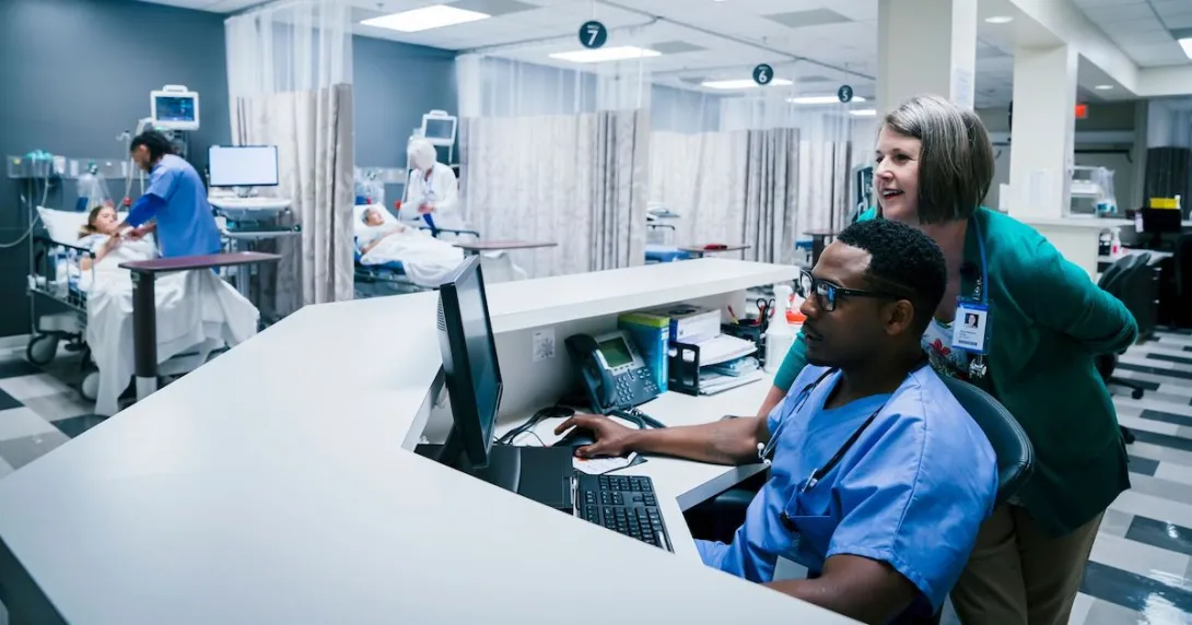 Providers using a computer in a hospital. Providers using a computer in a hospital.