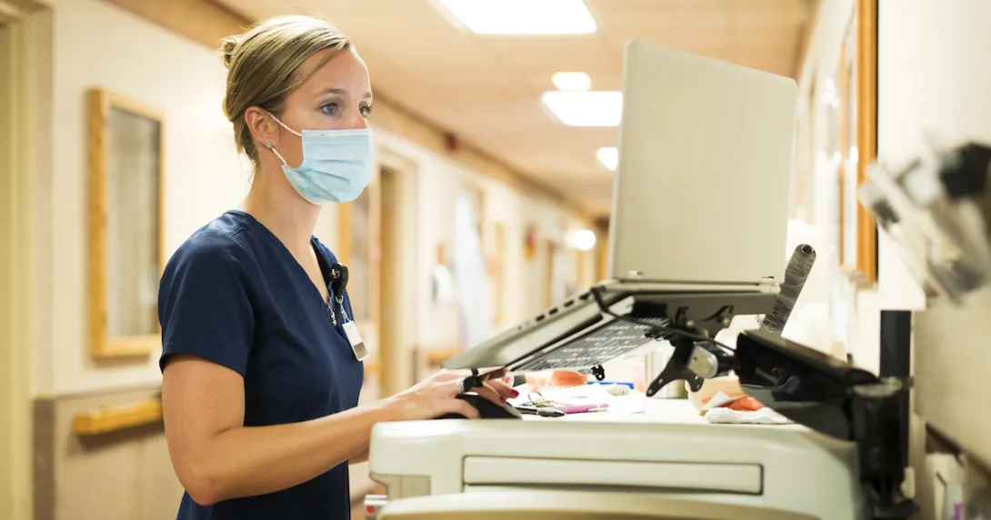 A nurse working at a computer in a hospital A nurse working at a computer in a hospital