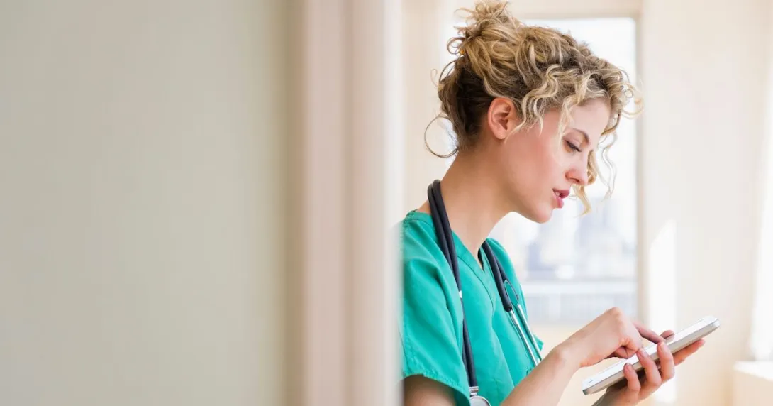 A provider typing onto a tablet A provider typing onto a tablet