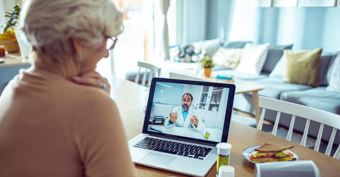 An older woman talking a doctor via telehealth An older woman talking a doctor via telehealth
