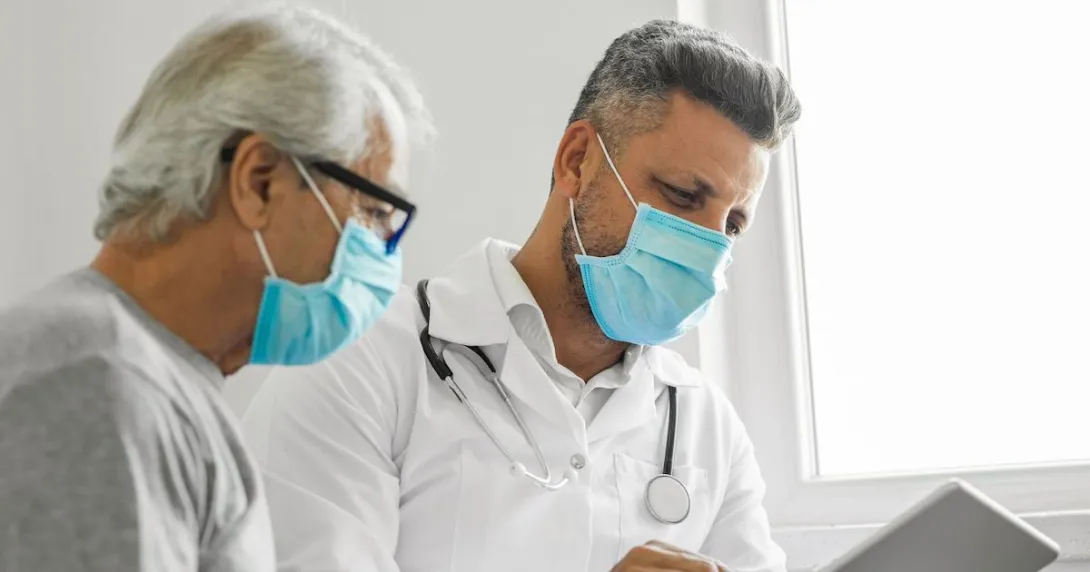 An older man and his doctor looking at a tablet An older man and his doctor looking at a tablet
