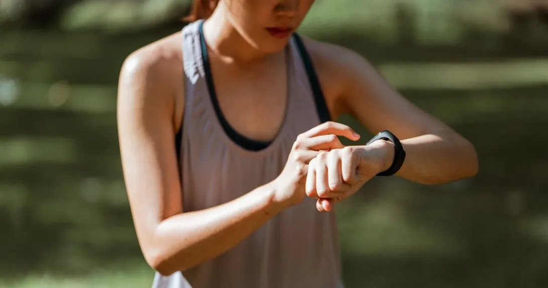 A runner checking their vital signs on their fitness tracker A runner checking their vital signs on their fitness tracker
