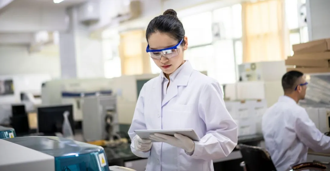 A researcher using her tablet in a lab A researcher using her tablet in a lab