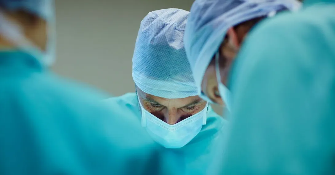 A close up of surgeons working in an operating room.