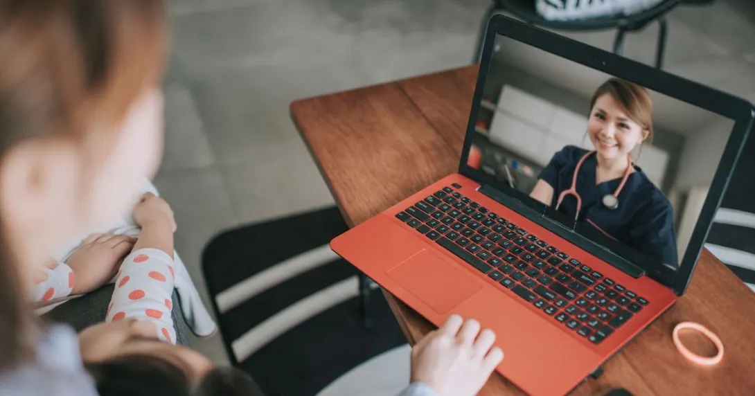 A woman talking to a provider via her laptop A woman talking to a provider via her laptop
