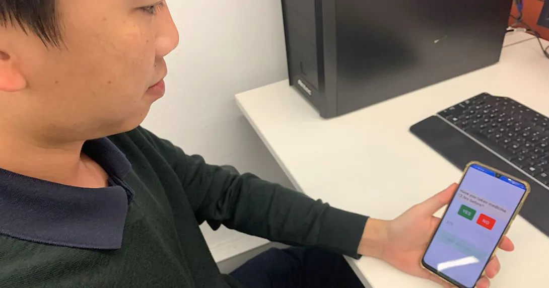 A researcher demonstrating the voice screening app