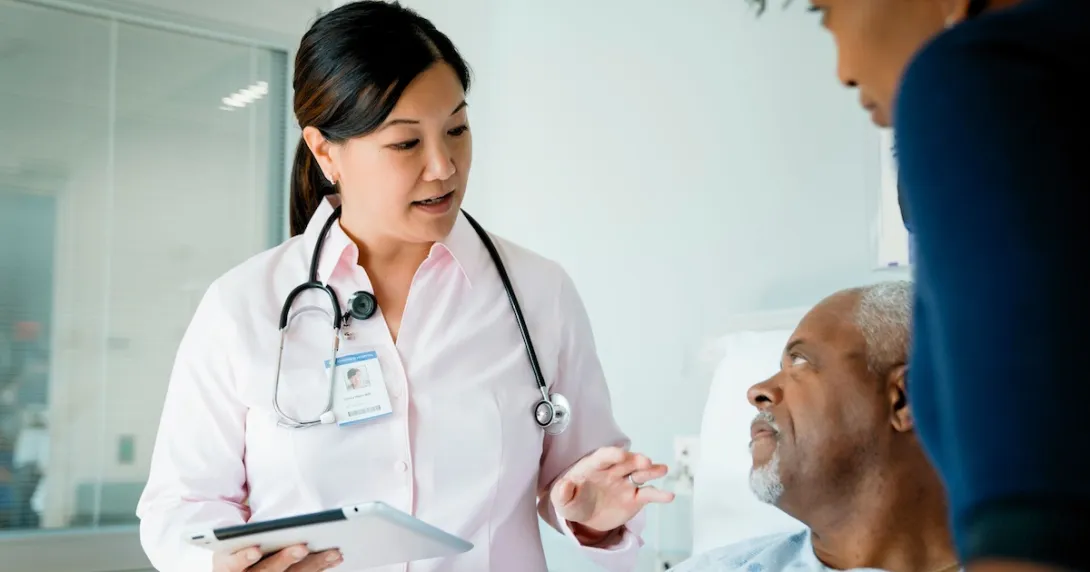 Healthcare provider with a patient and their caregiver Healthcare provider with a patient and their caregiver