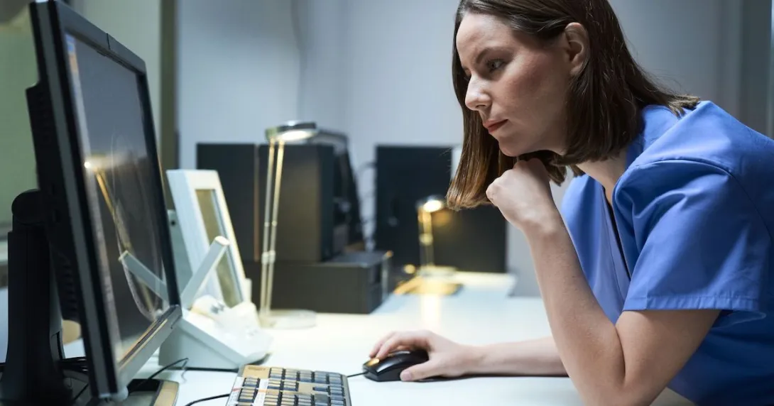 Healthcare provider sitting at a computer Healthcare provider sitting at a computer