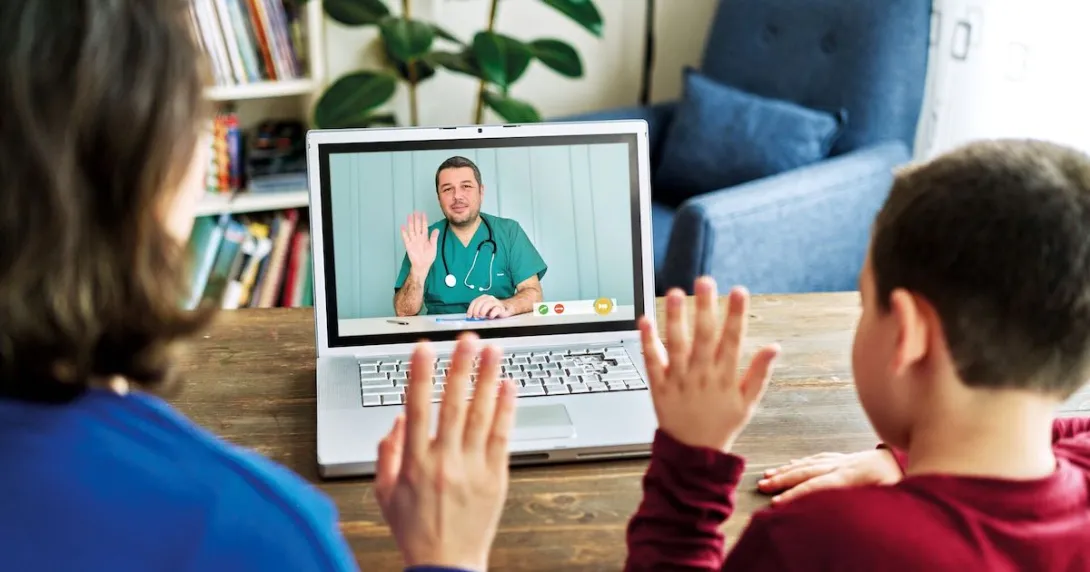 Two people waving at a healthcare provider on a computer Two people waving at a healthcare provider on a computer