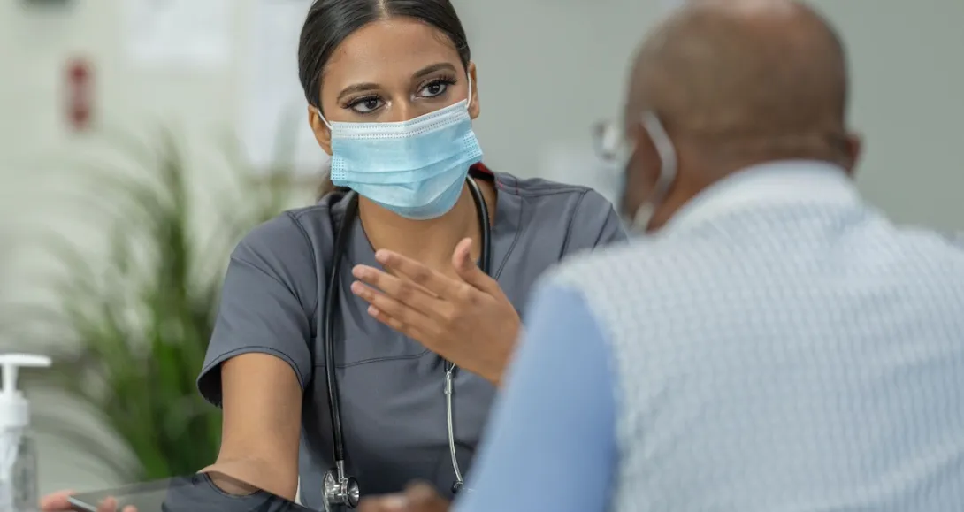 Healthcare provider sitting and talking to a patient Healthcare provider sitting and talking to a patient