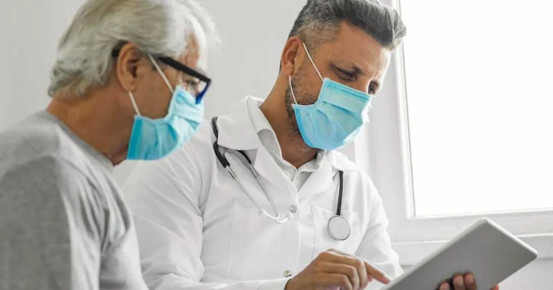 Healthcare provider and patient looking at a tablet Healthcare provider and patient looking at a tablet
