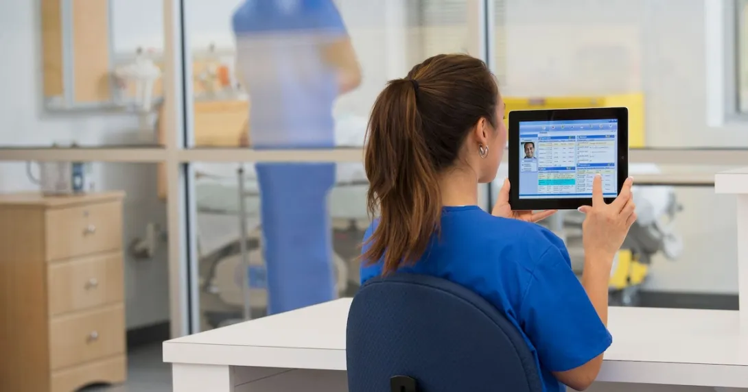 Healthcare provider sitting at a desk in the clinical setting while looking at a computer Healthcare provider sitting at a desk in the clinical setting while looking at a computer