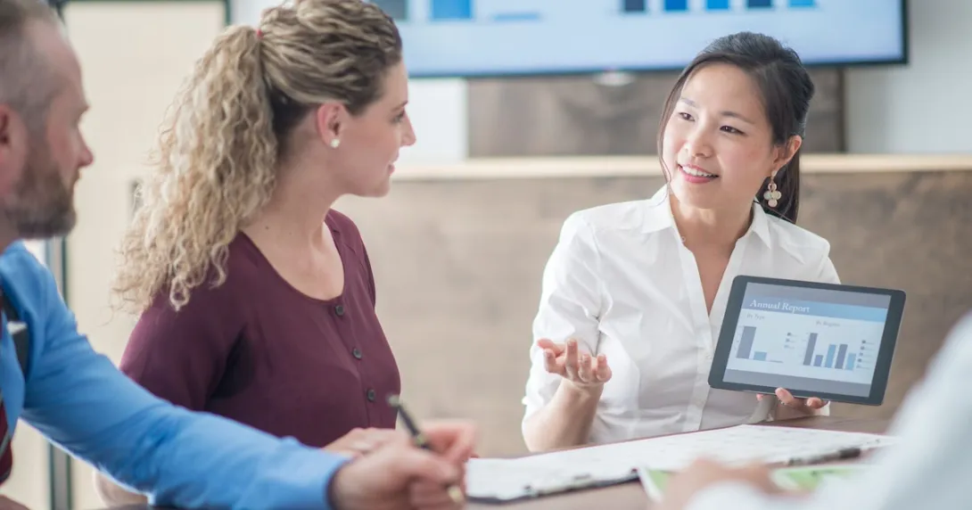 People sitting around a table talking to each other People sitting around a table talking to each other