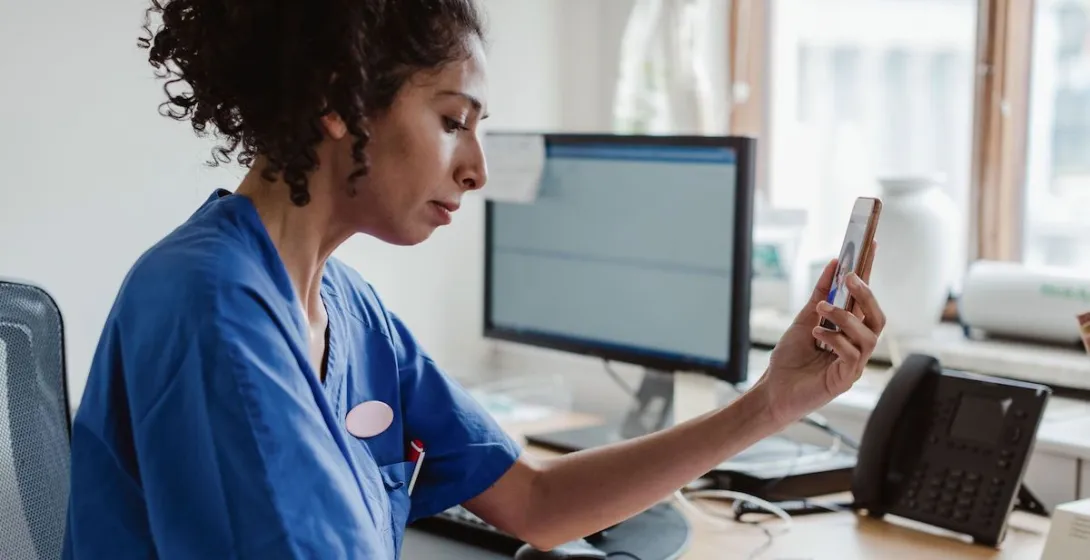 A doctor talking with a patient on a video call on her smartphone. A doctor talking with a patient on a video call on her smartphone.