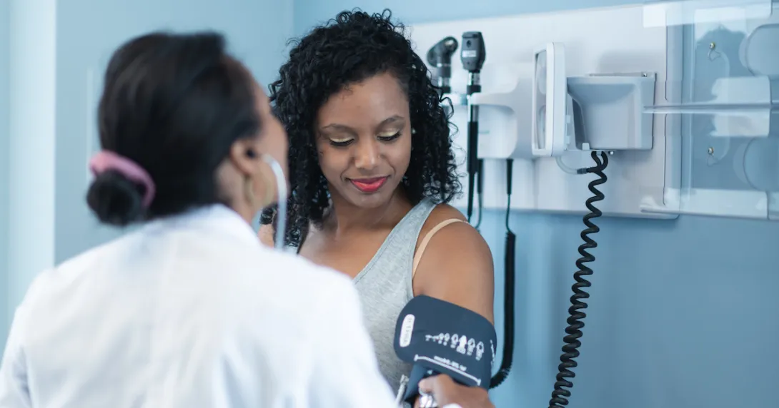 A provider checking blood pressure during an appointment A provider checking blood pressure during an appointment