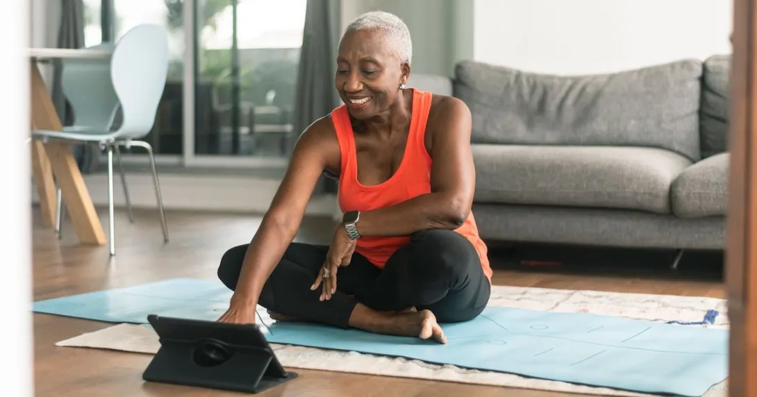 A woman exercising while using a tablet A woman exercising while using a tablet