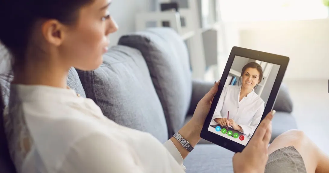 A woman talking to a provider on her tablet A woman talking to a provider on her tablet